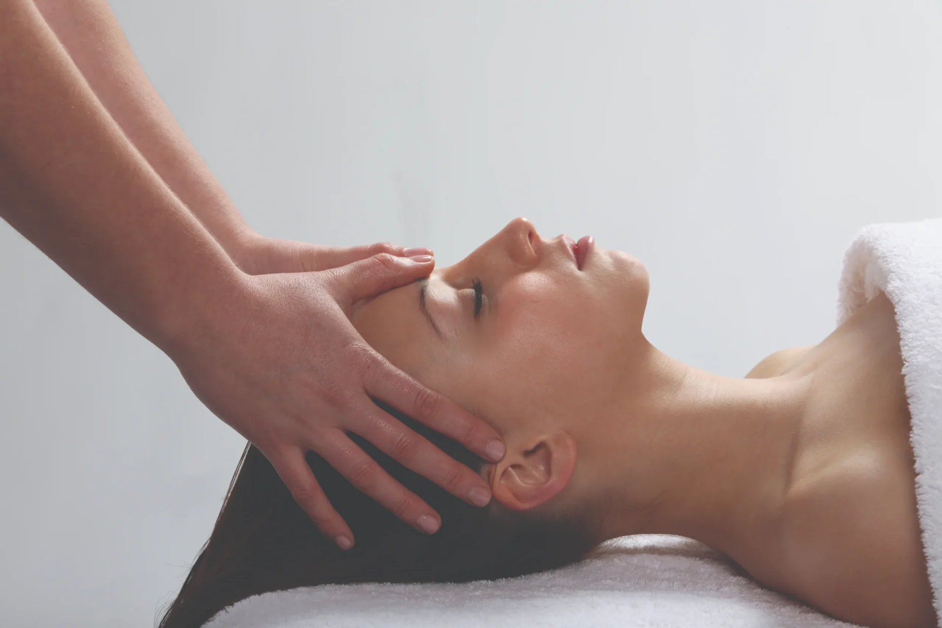 Woman receiving facial reflexology